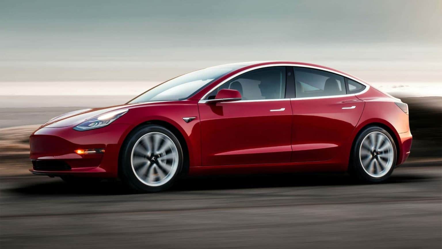 Tesla-Model-3-Red-Driving-Sunset